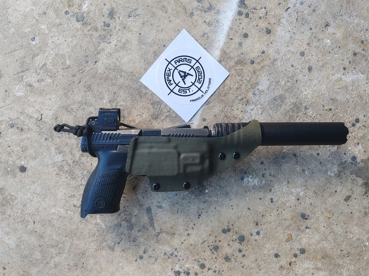 Custom olive Kydex holster system formed around a specialised firearm setup