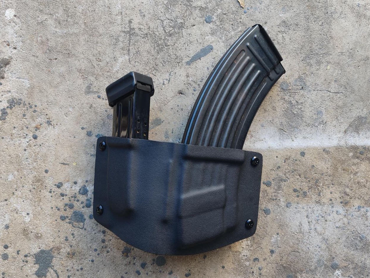 Custom black Kydex carrier holding two different magazine profiles