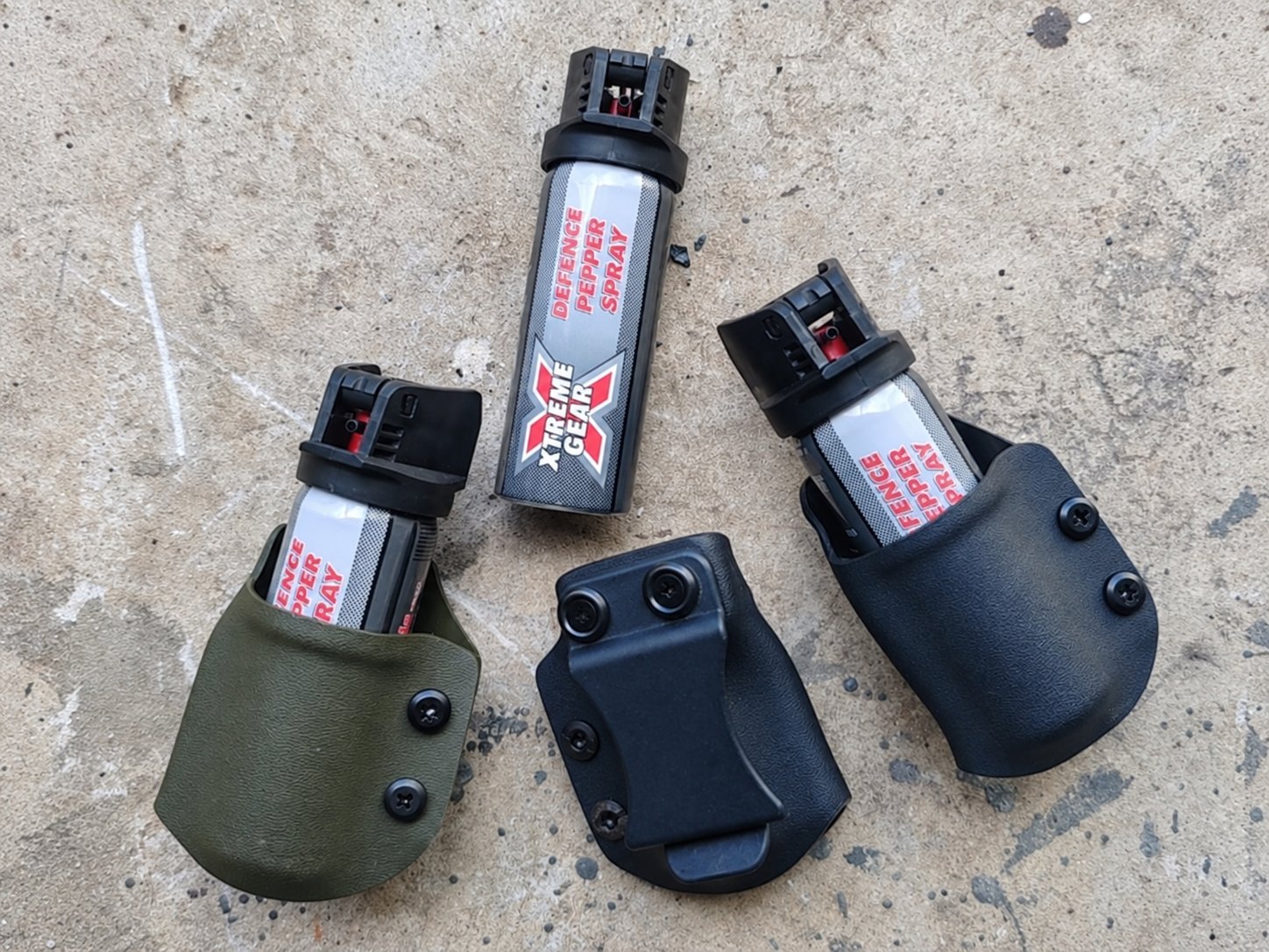Custom Kydex pepper spray carrier on workshop counter